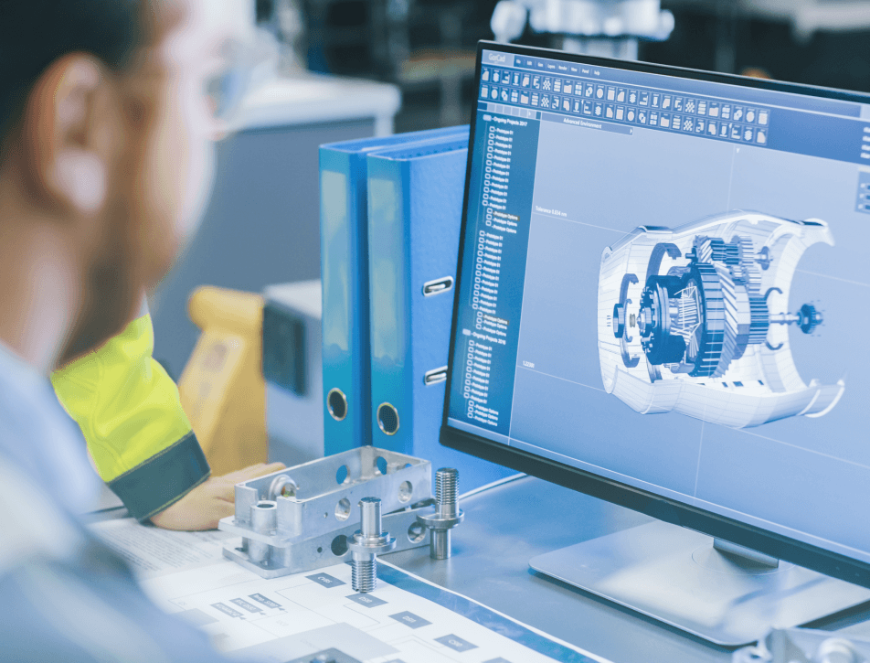 Engineer in safety gloves reviews a 3D CAD rendering of a mechanical assembly beside blueprints and tools in a workshop.