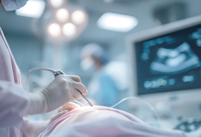 A surgeon's gloved hand operates on a patient in a sterile room, with medical monitors displaying vital information. The atmosphere is focused and clinical.